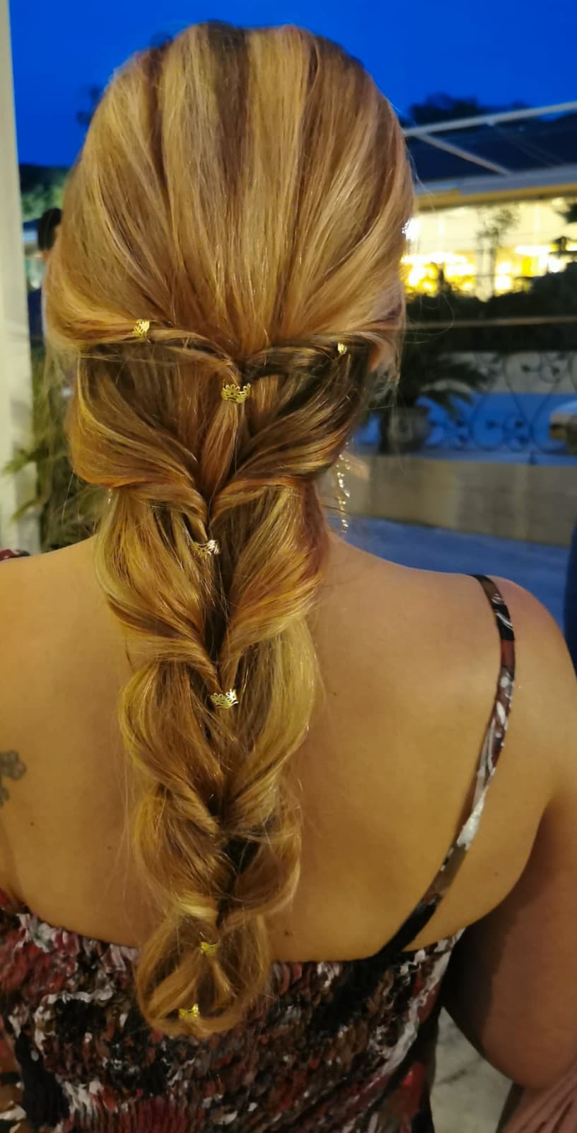 Trenza de espiga suelta con horquillas doradas, de noche en una boda